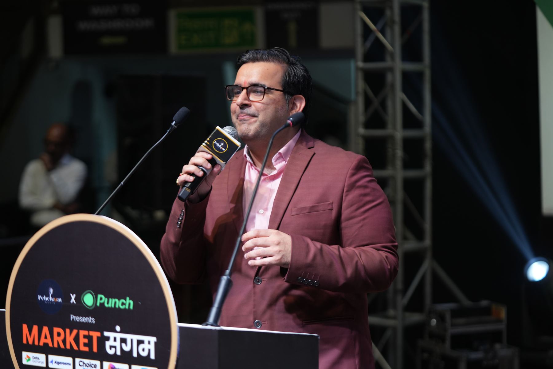 Speaker on stage with mic